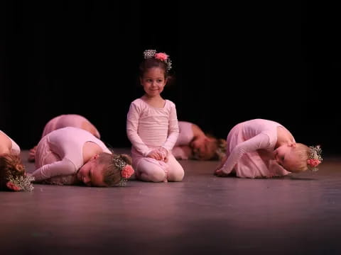 a group of girls in pink dresses