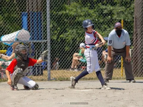 a kid swinging a baseball bat