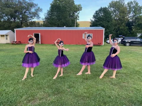 a group of girls in purple dresses