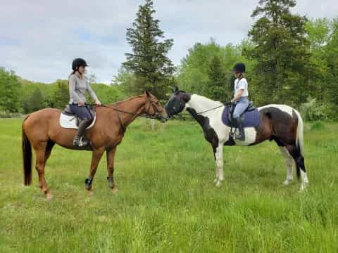 two women riding horses