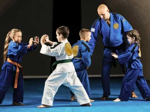 a group of people in blue karate uniforms