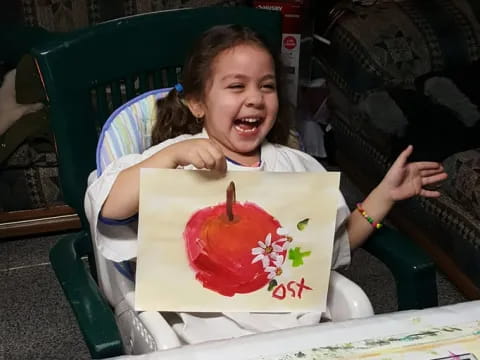 a girl sitting in a chair with a birthday cake