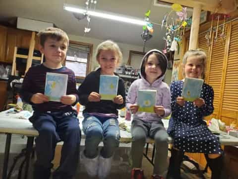 a group of children holding up books