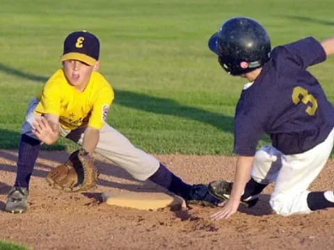 a couple of young boys playing baseball