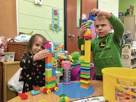 a couple of kids playing with toys