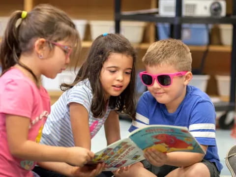a group of children reading a book