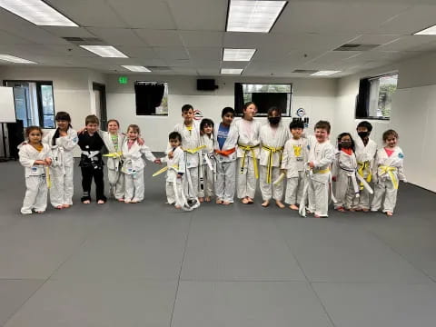 a group of people in white karate uniforms