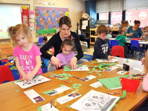 a person and several children sitting at a table