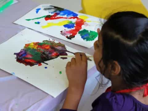 a child painting on a white board