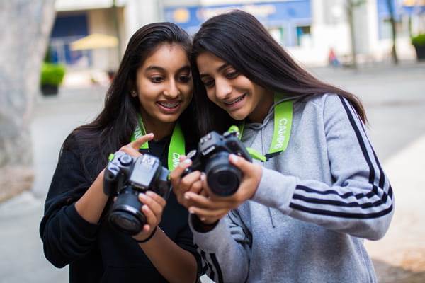 a couple of women holding cameras