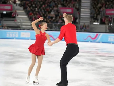 a man and woman ice skating