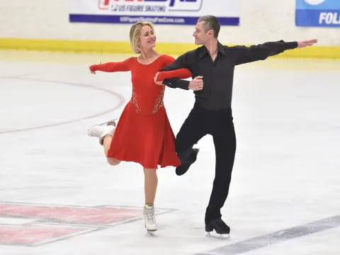 a man and woman ice skating