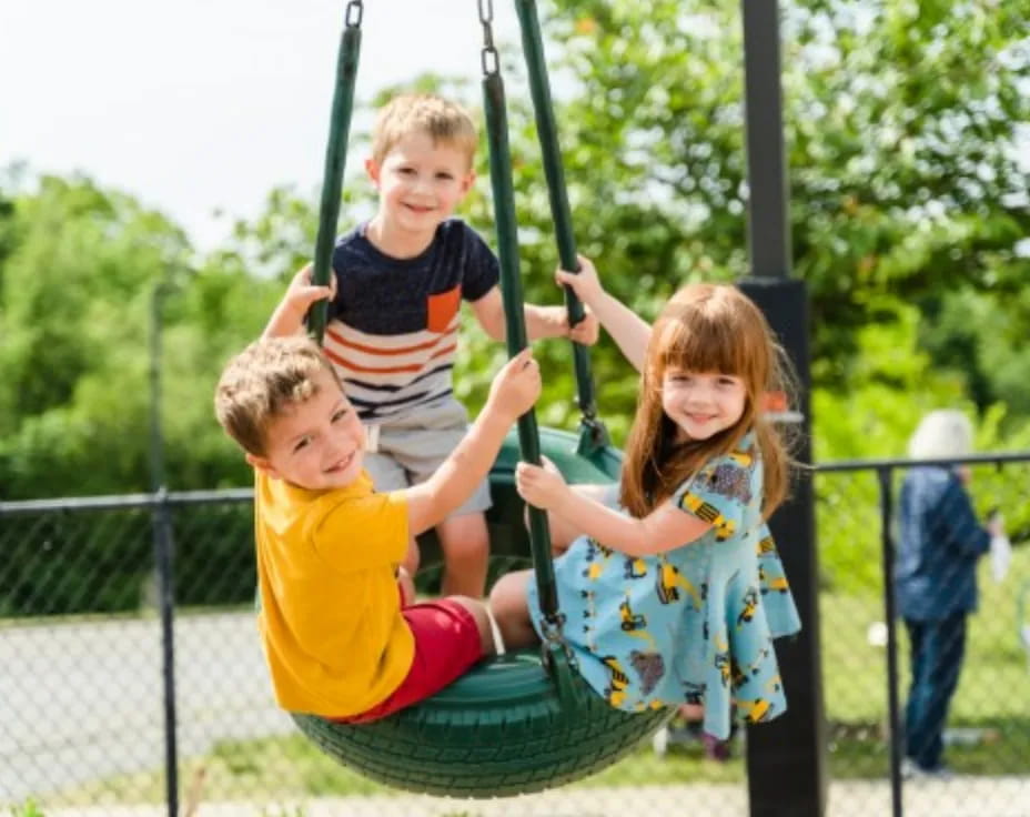 a group of children on a swing