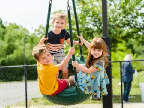 a group of children on a swing