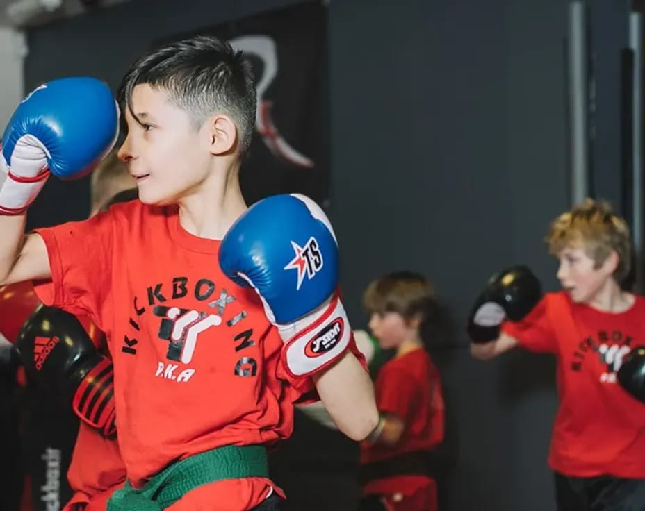 a group of kids wearing boxing gloves