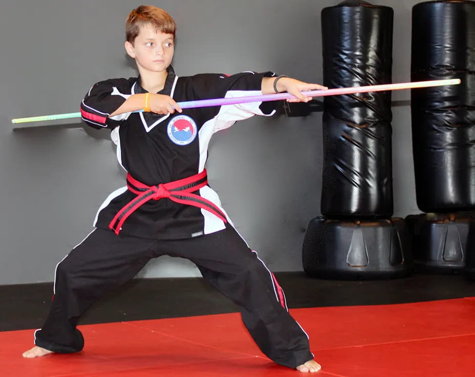 a boy in a martial arts uniform