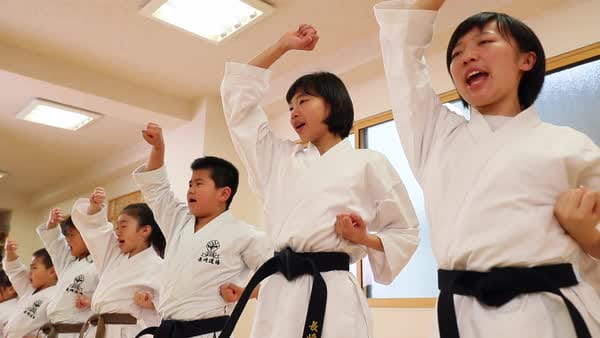 a group of men in karate uniforms