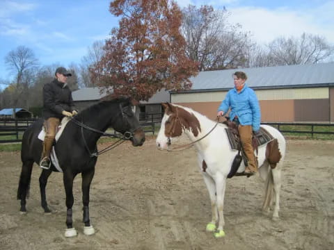 a couple of people riding horses