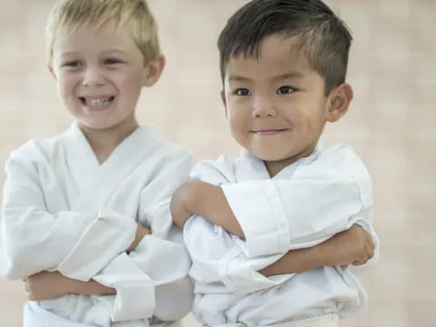 two boys wearing white shirts