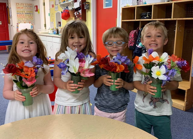 a group of children holding flowers