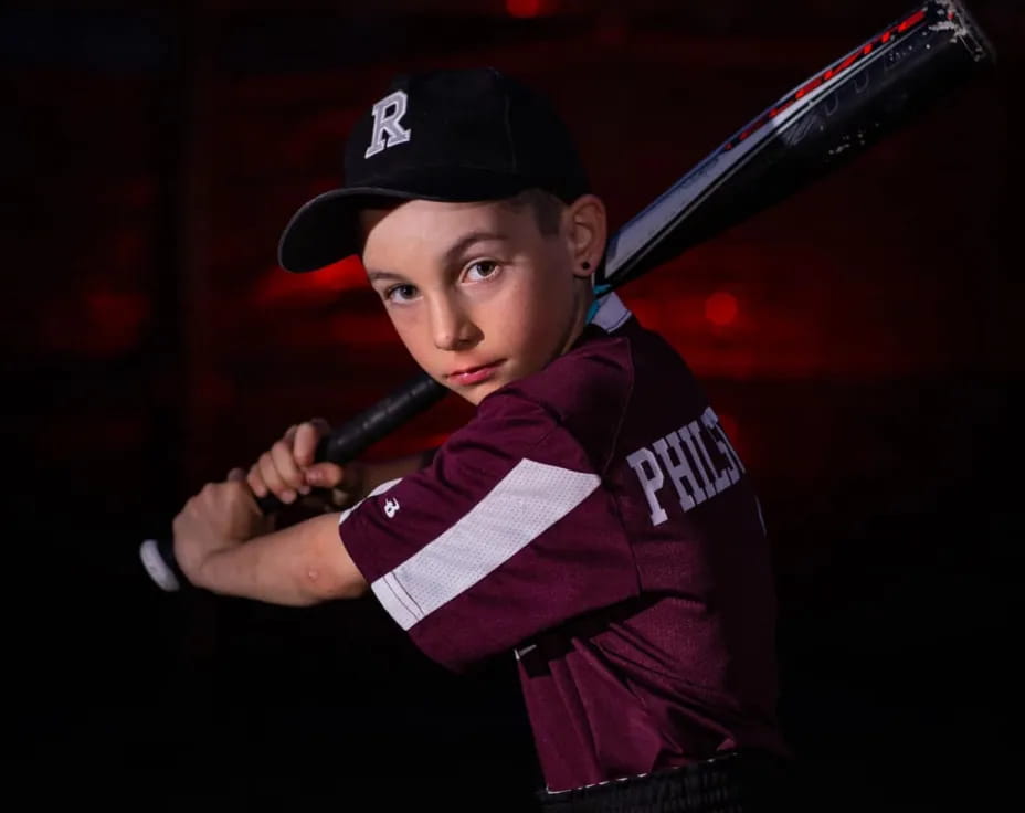 a boy holding a baseball bat