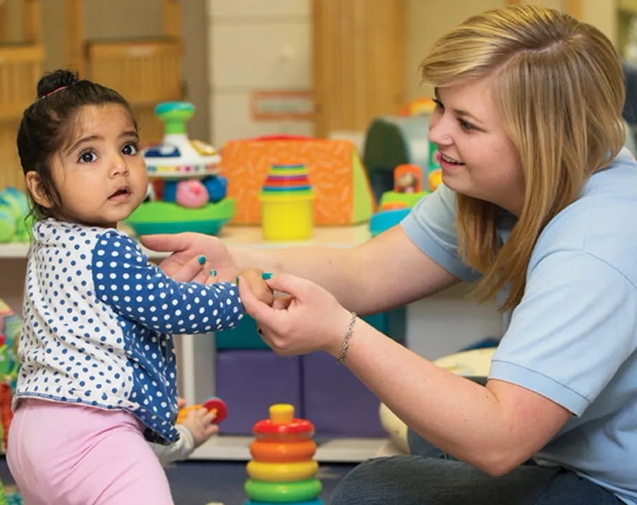 a person and a child playing with toys