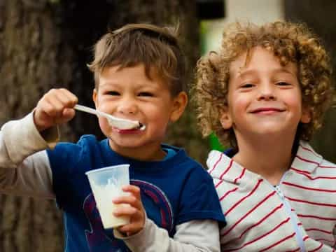 a couple of kids brushing their teeth