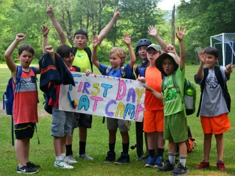 a group of kids holding a sign