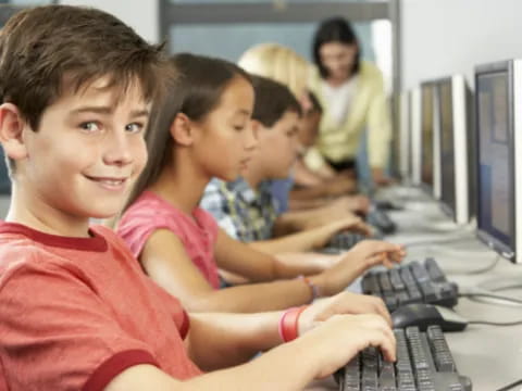 a group of children using computers
