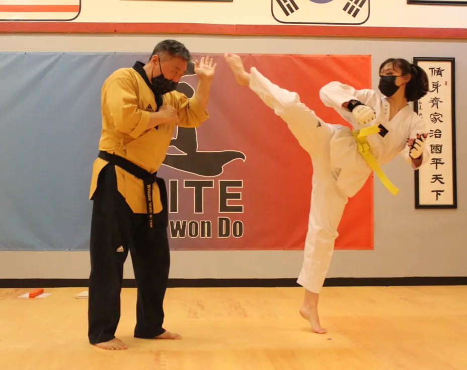 a man and woman in karate uniforms