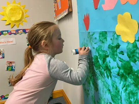a girl painting on a wall