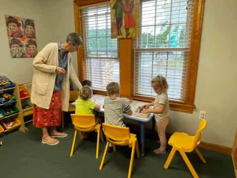 a person and children in a classroom