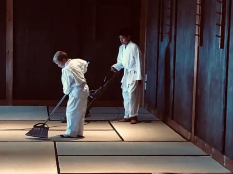 a couple of men cleaning the floor