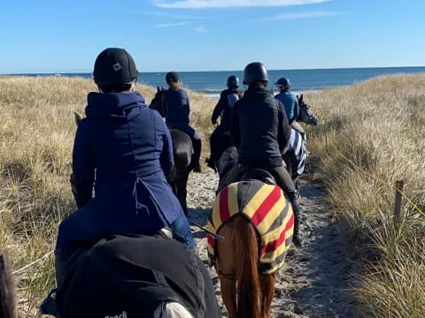 a group of people riding horses