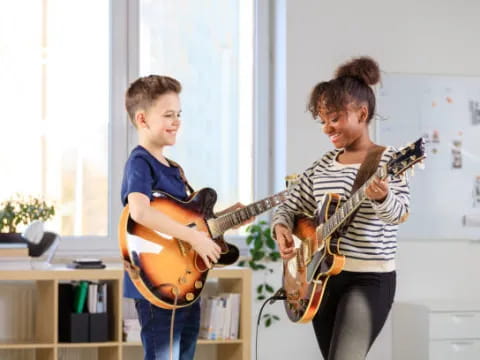 two boys playing guitars