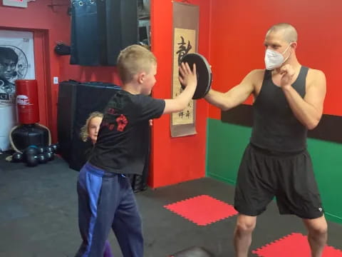 a person and a boy in a gym