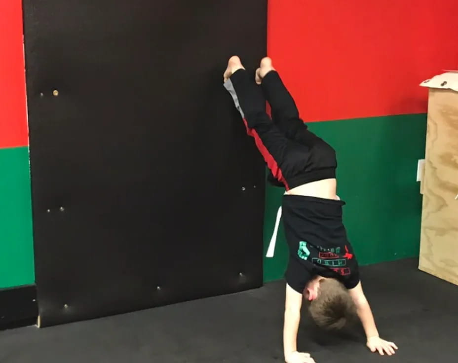 a person doing a handstand on the floor