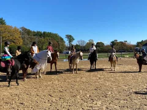 a group of people riding horses