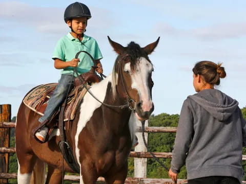 a man and a child riding a horse