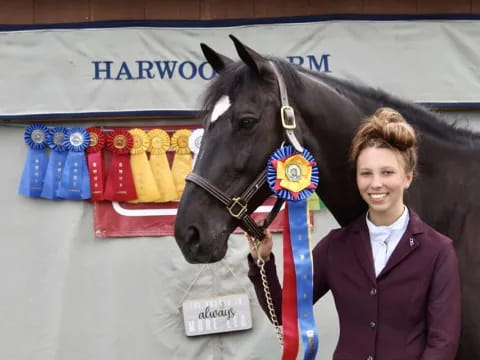 a person standing next to a horse