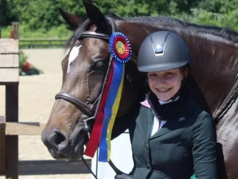 a person standing next to a horse