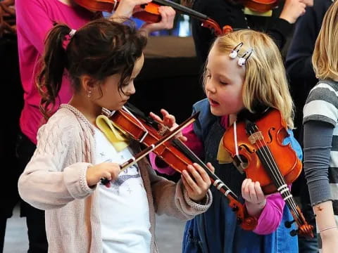 a group of girls playing violin