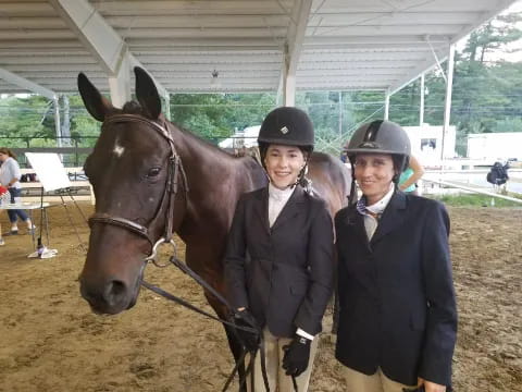 a couple of people posing with a horse