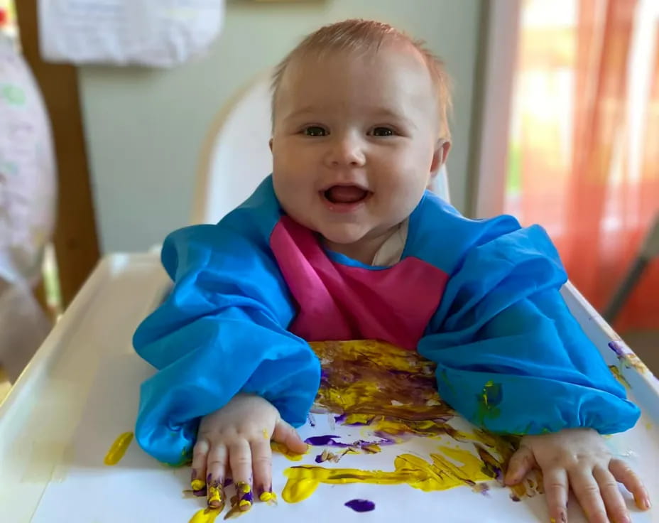 a baby sitting at a table