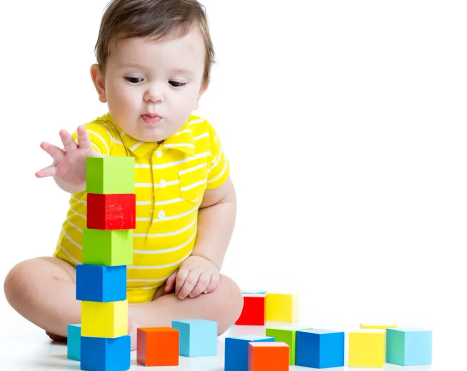 a baby sitting on a pile of blocks