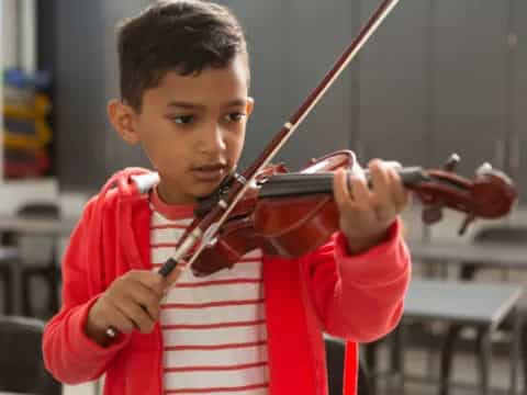 a boy playing a violin