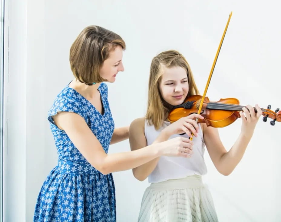 a couple of girls playing violin