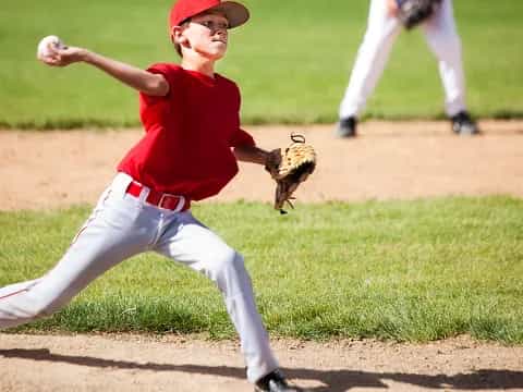 a kid throwing a baseball
