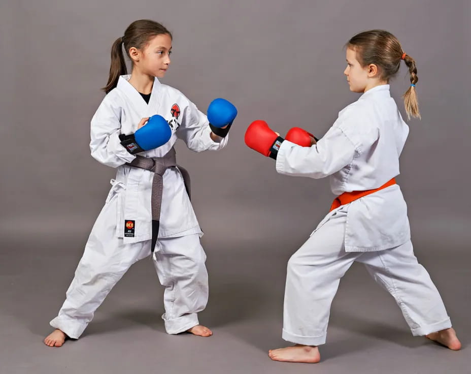 two girls in karate uniforms