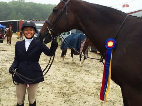 a person standing next to a horse